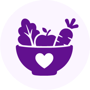 A purple icon of a bowl with a heart on it, filled with a carrot, leafy greens, and an apple, symbolizing healthy or vegetarian food.